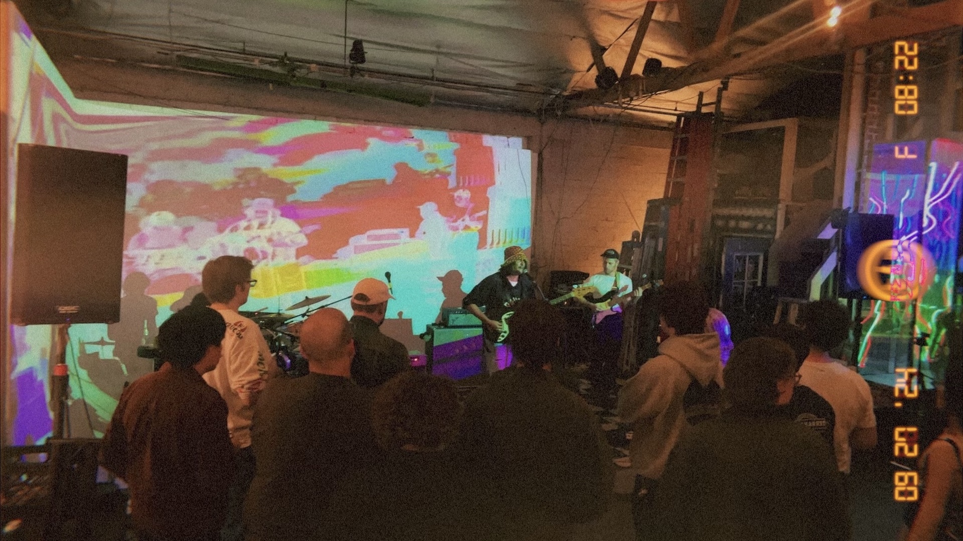 Art of Nothing Press Event with Band Playing. Trippy effects being projected behind on stage.
